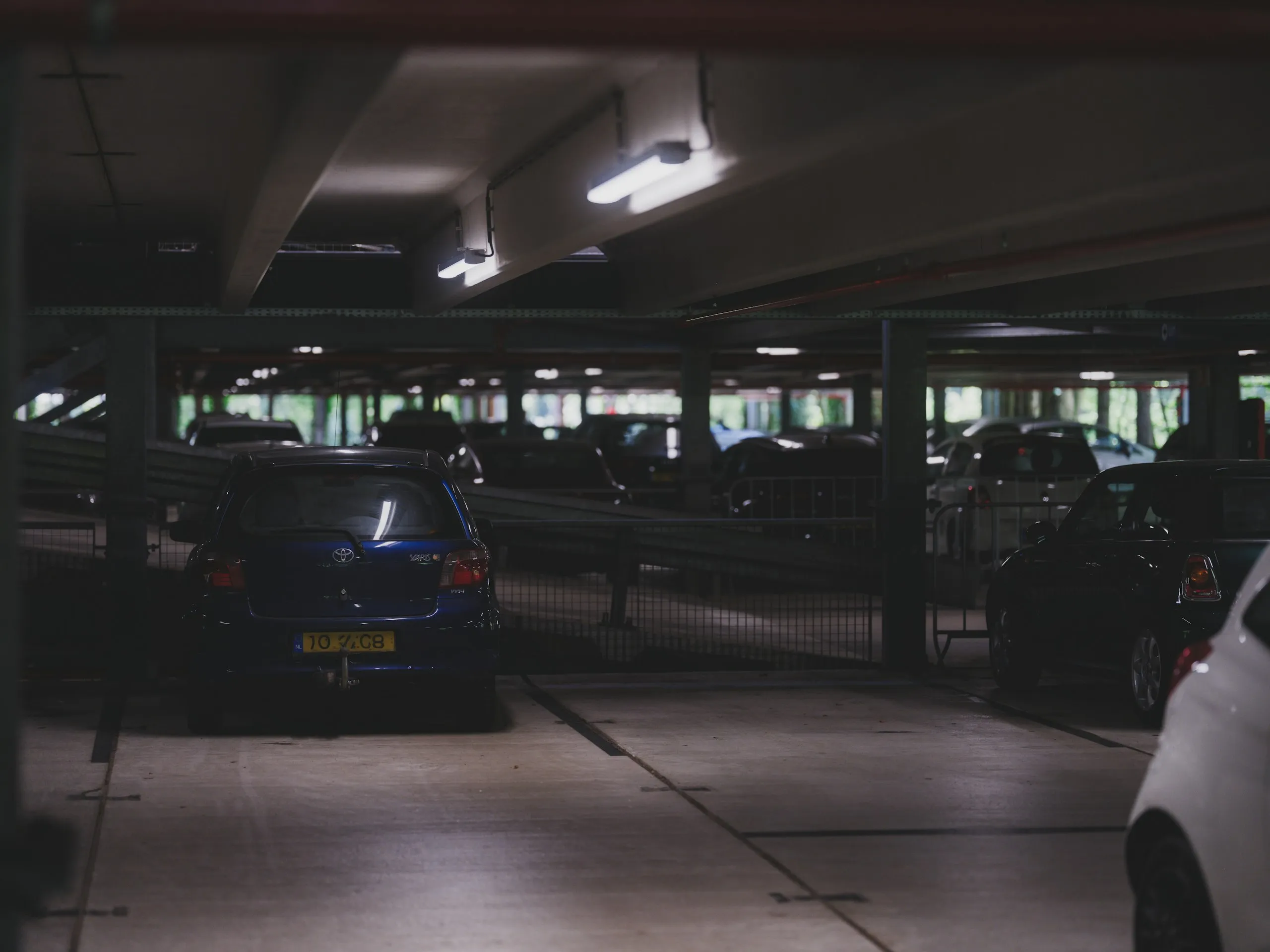 Cars parked inside a multi-level parking garage